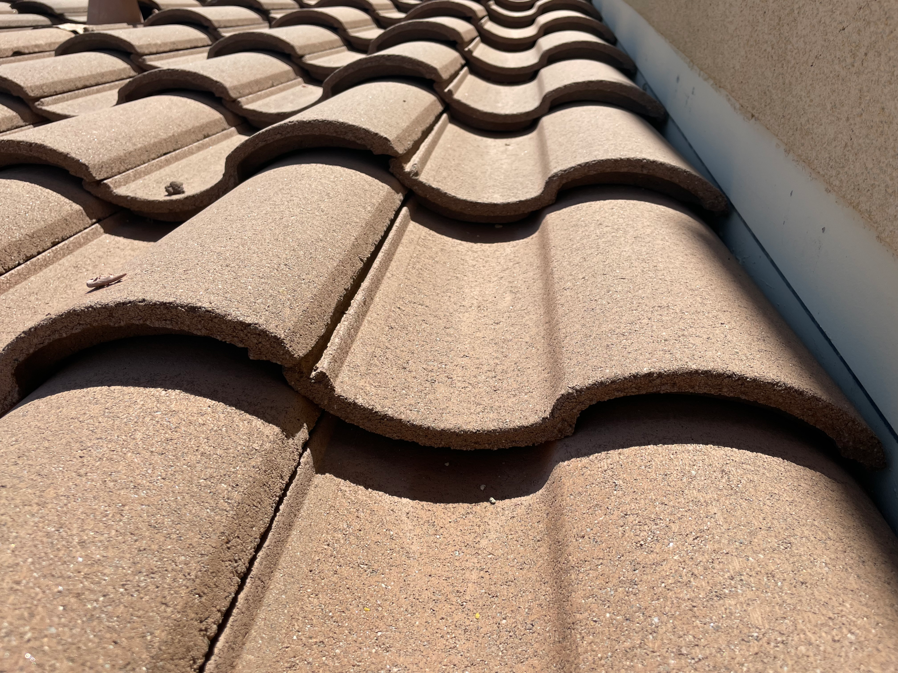 A closeup photo of a brown concrete tile roof