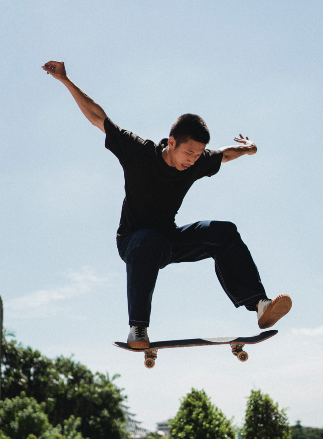 A man jumps into the air on a skateboard.